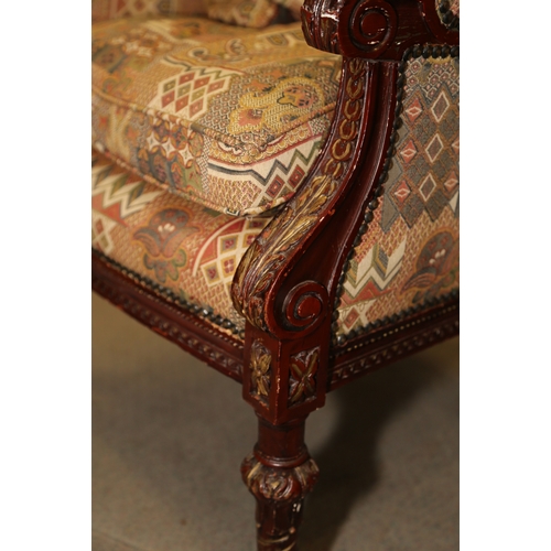 277 - A French carved and painted open armchair, upholstered in a patterned fabric, on turned and carved s... 