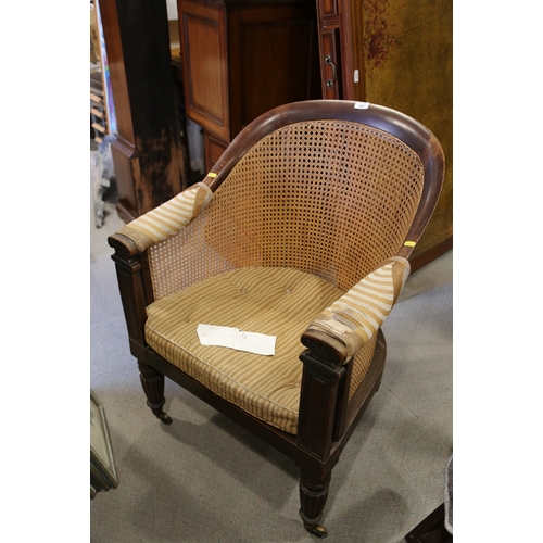 280 - A 19th century mahogany tub chair with caned seat and back, on reeded supports (seat damaged)