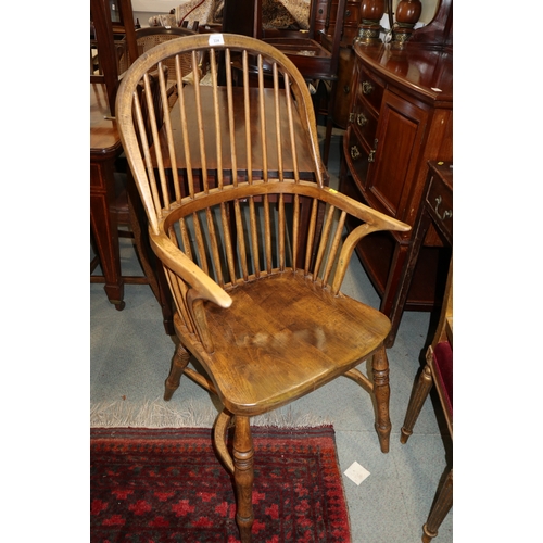 334 - A Windsor spindle back elbow chair with beech panel seat, on turned crinoline stretchered supports