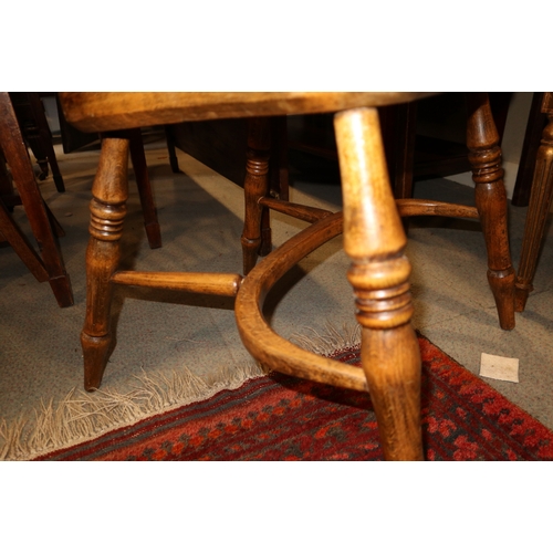 334 - A Windsor spindle back elbow chair with beech panel seat, on turned crinoline stretchered supports