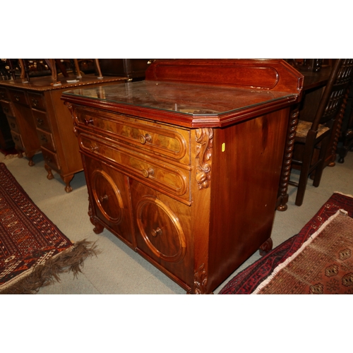 357 - A walnut ledge back side cabinet, fitted two long drawers over two short deep drawers, on carved cab... 