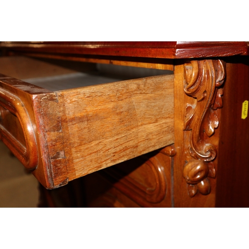 357 - A walnut ledge back side cabinet, fitted two long drawers over two short deep drawers, on carved cab... 