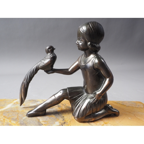 99 - An Art Deco bronzed figure group, girl with bird, on yellow marble base, 11