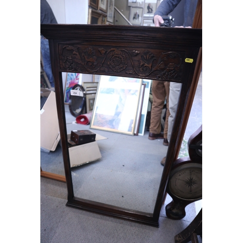 294 - A carved oak wall mirror with Tudor rose decoration, 36