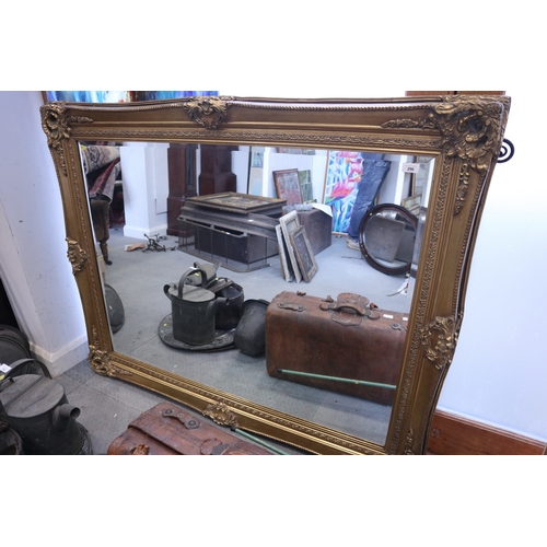 296 - A bevelled plate rectangular wall mirror, in ornate gilt frame, plate 36