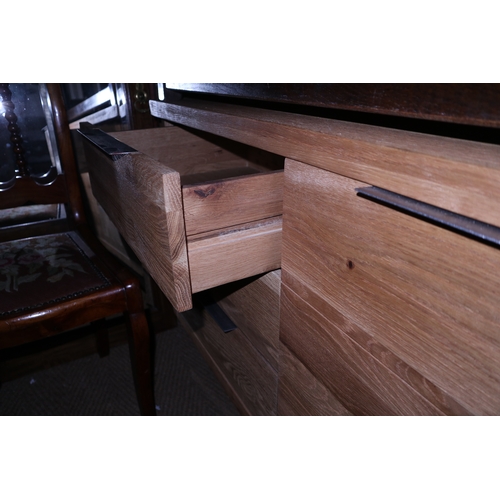 322 - A modern oak sideboard fitted one cupboard and three drawers, on metal supports, 47