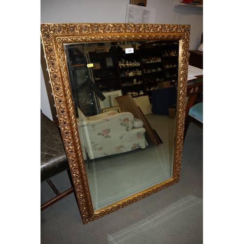 295 - A bevelled plate rectangular wall mirror, in ornate gilt frame, plate 36