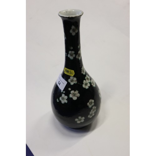 64 - A famille noir bottle vase with prunus decoration, 10