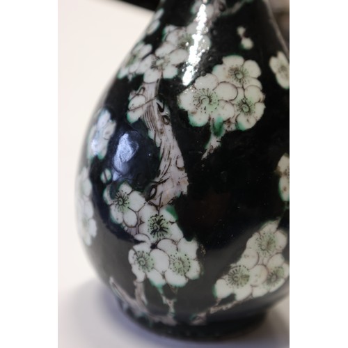 64 - A famille noir bottle vase with prunus decoration, 10