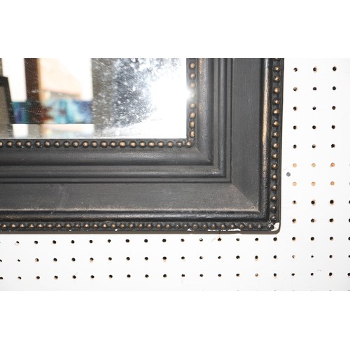 293 - A bevelled plate wall mirror, in beaded ebonised frame, 42