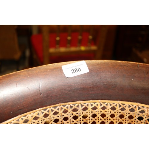 280 - A 19th century mahogany tub chair with caned seat and back, on reeded supports (seat damaged)