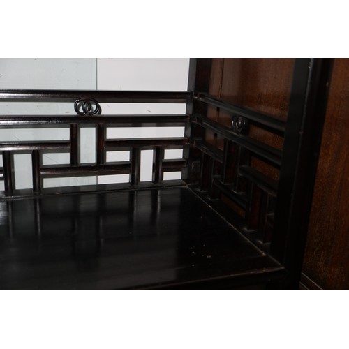 308 - A Chinese ebonised hardwood open bookcase, fitted two centre drawers, 34