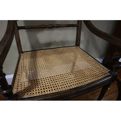 272 - A late 19th century polished as walnut Louis XVI design open armchair with cane seat and back, on tu... 