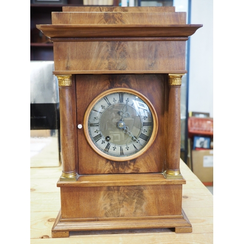 135 - A 19th century Danish figured mahogany mantel clock with silvered chapter ring and eight-day strikin... 