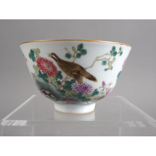 106 - A Chinese porcelain bowl with bird, flower and insects in a landscape decoration, four-character mar... 