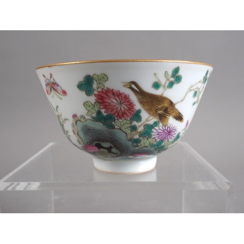 106 - A Chinese porcelain bowl with bird, flower and insects in a landscape decoration, four-character mar... 