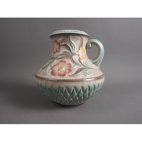 22 - An H J Wood Art Deco floral relief decorated jug, 8 1/2