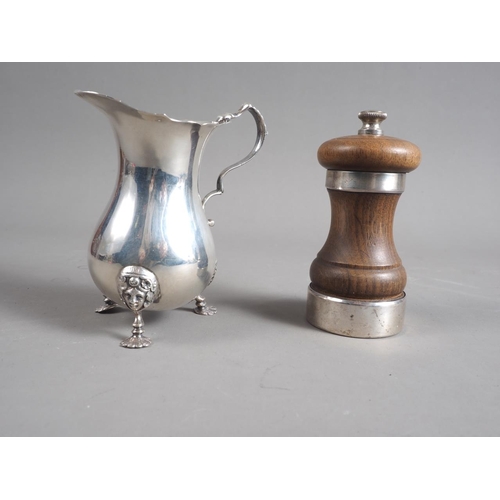 323 - A silver sugar caster, a silver cream jug and a silver mounted pepper grinder, 8.6oz troy approx wei... 