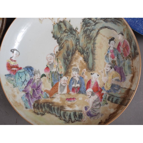 83 - A Chinese porcelain famille rose shallow dish, decorated numerous figures in a landscape, 8 1/4