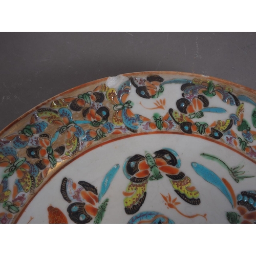 83 - A Chinese porcelain famille rose shallow dish, decorated numerous figures in a landscape, 8 1/4