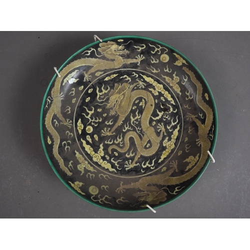 83 - A Chinese porcelain famille rose shallow dish, decorated numerous figures in a landscape, 8 1/4