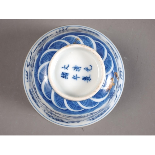 85 - A set of four Chinese porcelain blue and white bowls with flared rims, decorated dragons and clouds,... 