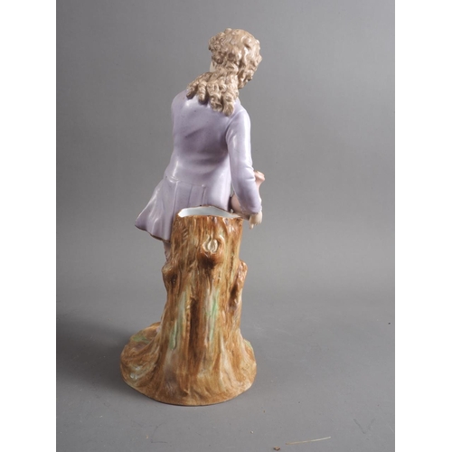 9 - A German porcelain figure/spill vase, formed as a young man holding a jug, 11