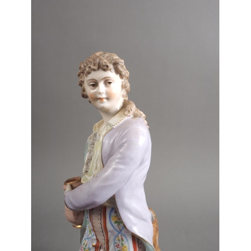 9 - A German porcelain figure/spill vase, formed as a young man holding a jug, 11