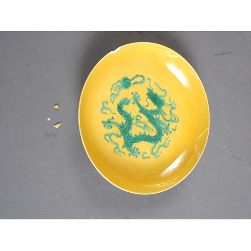 92 - A Chinese porcelain shallow dish, decorated dragons on a yellow ground, four-character mark to base,... 