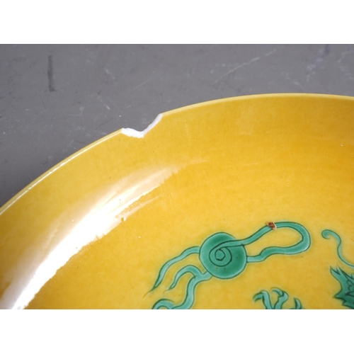 92 - A Chinese porcelain shallow dish, decorated dragons on a yellow ground, four-character mark to base,... 