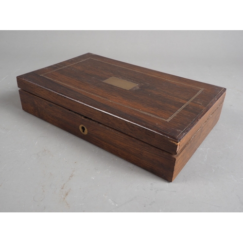 130 - An early 20th century brass bound rosewood box, containing a selection of drawing instruments