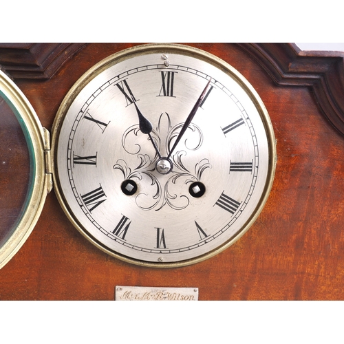 142 - An early 20th century mahogany cased mantel clock with silvered dial and eight-day striking movement... 