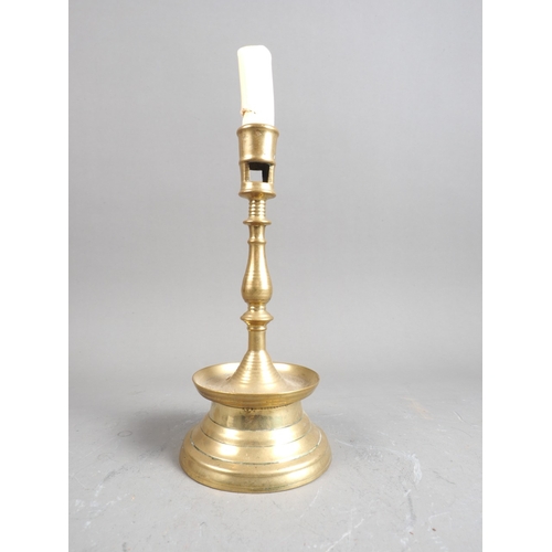 158 - An early 17th century brass capstan type candlestick, 8 1/4