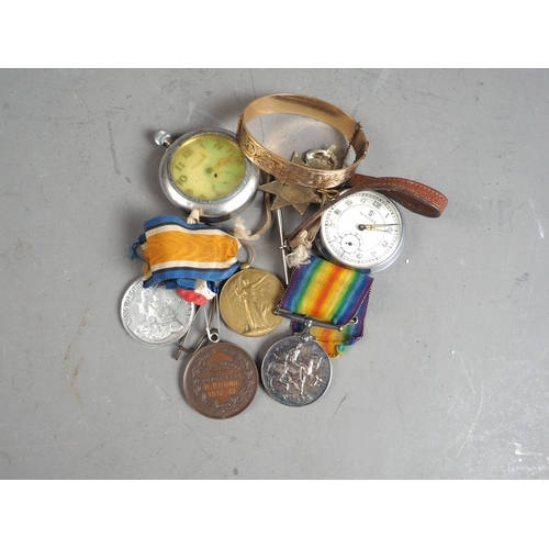 379 - Two WWI medals, awarded to 159355 Gunner G E Gifkins, a cap badge, two commemorative medals, two poc... 