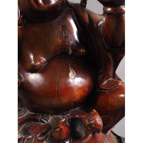 111 - A carved hardwood Hotei with children, 8