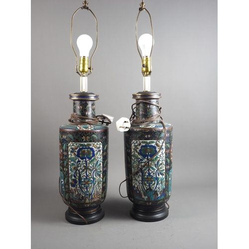 119 - A pair of early 20th century cloisonne vases with floral panels on a dark blue ground, now converted... 