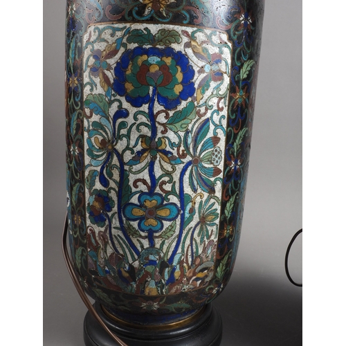 119 - A pair of early 20th century cloisonne vases with floral panels on a dark blue ground, now converted... 