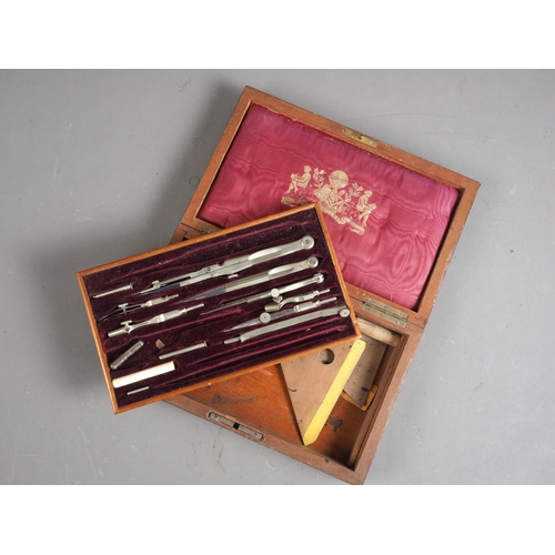 130 - An early 20th century brass bound rosewood box, containing a selection of drawing instruments