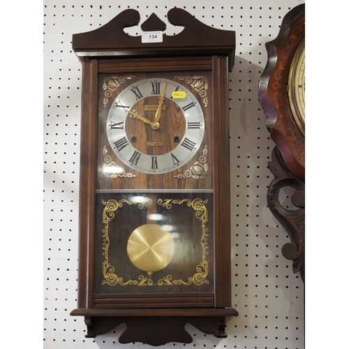 134 - A President polished as walnut cased wall clock with eight-day movement