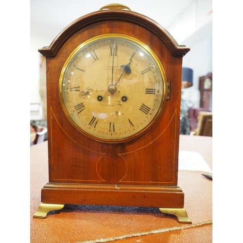 154 - A mahogany and line inlaid arch top bracket clock with cream painted dial and roman numerals, signed... 