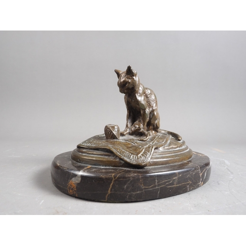 174 - C E Fremiet: a bronze model of a cat on a mat, on marble base, 4 1/8