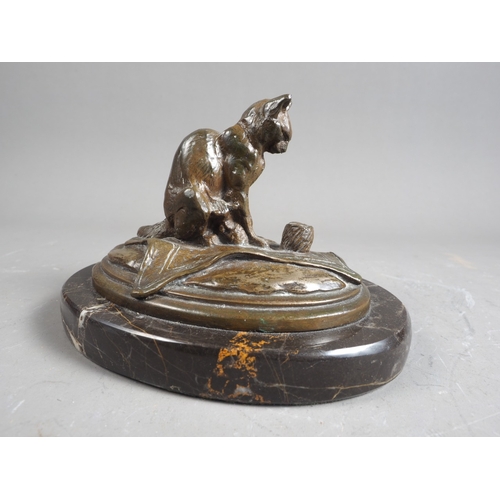 174 - C E Fremiet: a bronze model of a cat on a mat, on marble base, 4 1/8