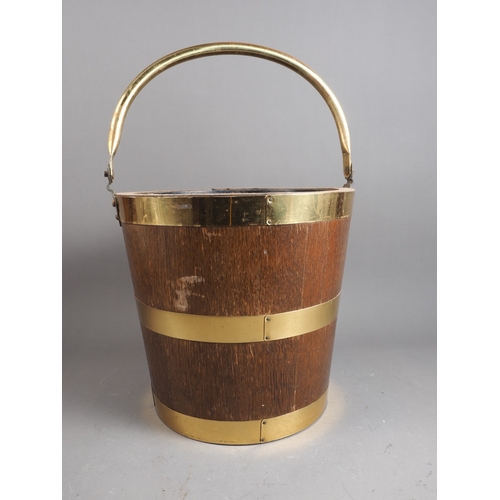 181 - An oak and brass swing handled 