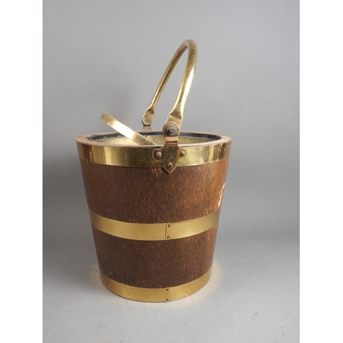 181 - An oak and brass swing handled 