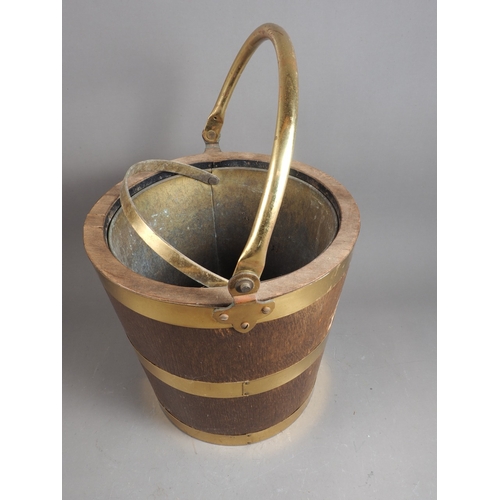 181 - An oak and brass swing handled 