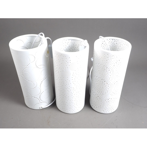 249 - Three pierced porcelain cylindrical table lamps, 11