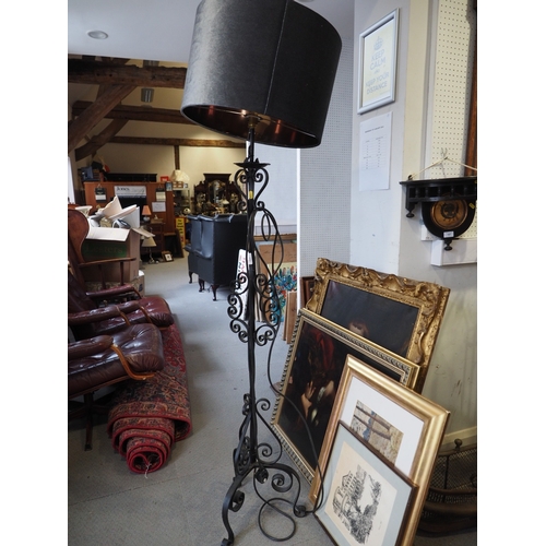 252 - A wrought iron standard lamp, on tripod scroll base, 56