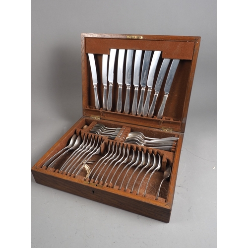 292 - An oak canteen of silver plated cutlery (two knives missing)