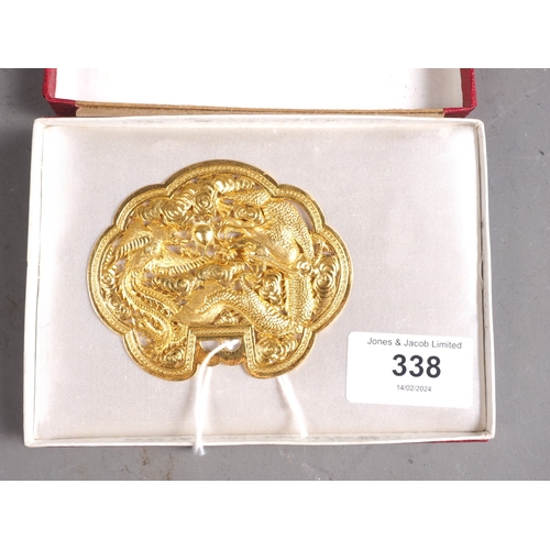 338 - A Chinese yellow metal cloud-shaped pendant with pierced and engraved decoration of two dragons and ... 