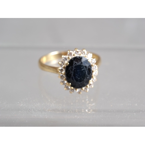 350 - A yellow metal, sapphire and diamond cluster ring, size T/U, 5.8g